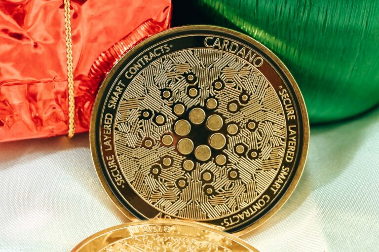 a gold coin sitting next to a red bag